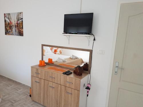 科托尔Bestie House的一间设有镜子的客房,墙上配有电视