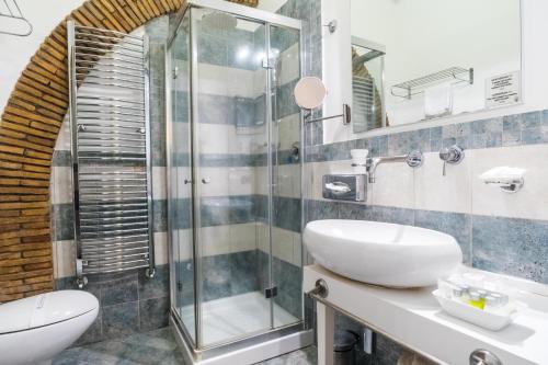 a bathroom with a sink and a shower at Hotel Villa Tirreno in Tarquinia