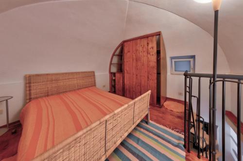 a bedroom with a bed and an open door at Casa Tinin in Loano