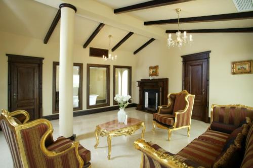a living room with a couch and chairs and a table at Arena Regia Hotel & Spa - Marina Regia Residence in Mamaia Nord