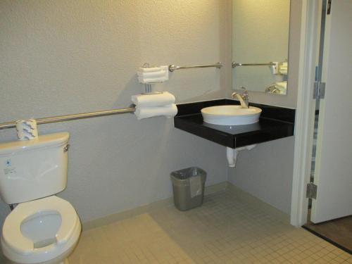 a bathroom with a toilet and a sink at Motel 6-Fort Wayne, IN in Fort Wayne