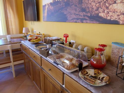 a kitchen with a counter with food on it at Casa Venere in Lampedusa