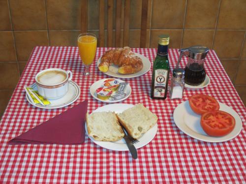 a red and white checkered table with food and drinks at Hotel Chola in Dorna