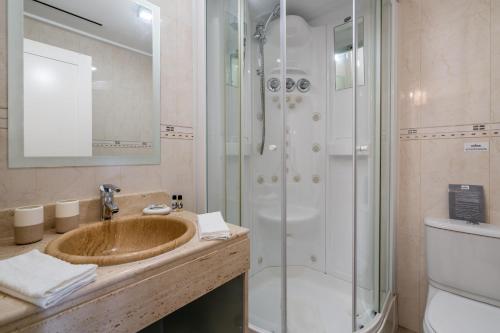 a bathroom with a sink and a shower at CAROB APARTMENT - BY MAYORAL (FALÉSIA BEACH) in Olhos de Água