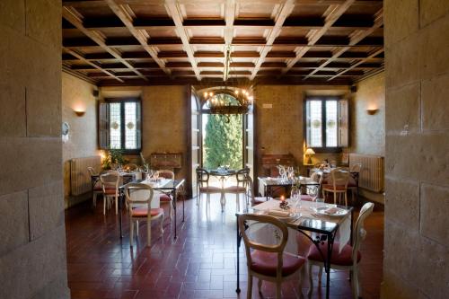 a dining room filled with tables and chairs at Villa Campestri Olive Oil Resort in Vicchio