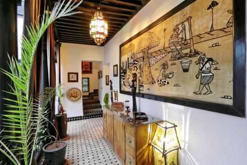 a hallway with a large painting on the wall at Dar Najat in Marrakech