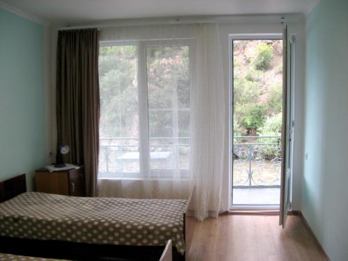 a bedroom with a bed and a sliding glass door at NEW SANAHIN in Alaverdi