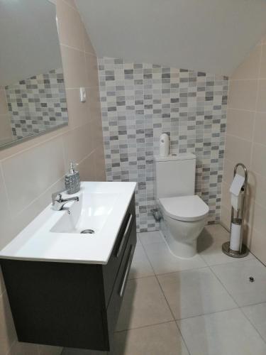 a bathroom with a sink and a toilet at Anevan in Vidago
