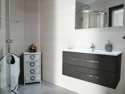 a bathroom with a sink and a mirror and a toilet at Anevan in Vidago