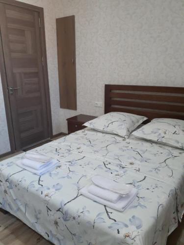 a bedroom with a bed with two towels on it at Apartments on Akhalubani St 2 in Tbilisi City