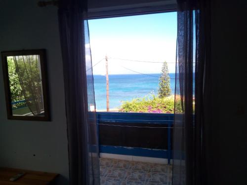 a view of the ocean from a room with a window at ThalaSEA Apartments in Chrani