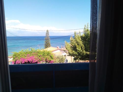 a view of the ocean from a window at ThalaSEA Apartments in Chrani