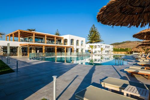 a resort with a swimming pool and a building at Solimar White Pearl - Adults Only in Kolymvari
