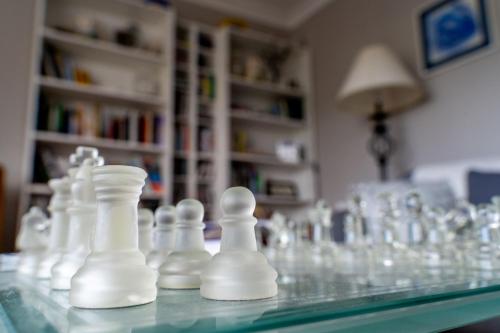 a glass chess set on a glass table at Coral Gables Guesthouse & Campsite in Rosslare