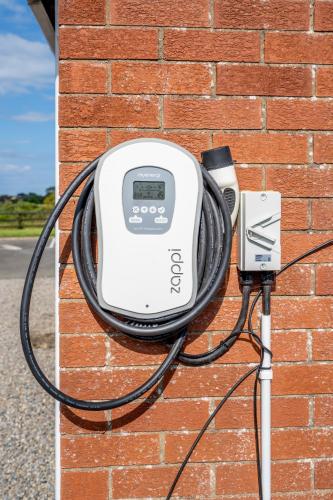 an electric device is attached to a brick wall at Coral Gables Guesthouse & Campsite in Rosslare