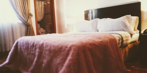 เตียงในห้องที่ Hotel Casa Gaia