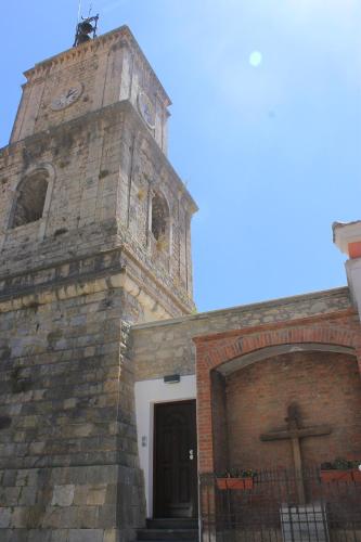 a church with a cross on top of it at L'Orologio Bed & Breakfast in Capaccio-Paestum