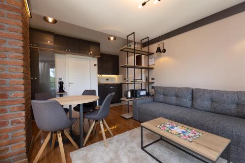 a living room with a couch and a table at Pampas apartments Mrežnica in Duga Resa