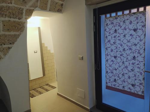 a bathroom with a large glass door with a mirror at Sweet Home Arco Porta Luce in Galatina