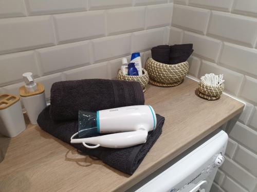 a hair dryer sitting on a counter in a bathroom at les lilas in Ozoir-la-Ferrière