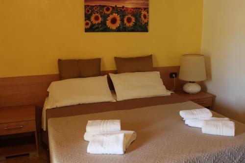 a bedroom with a bed with towels on it at B&B La Vigna in Lamezia Terme