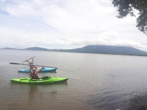 two people in kayaks on a large body of water at Hospedaje Bananas in Altagracia