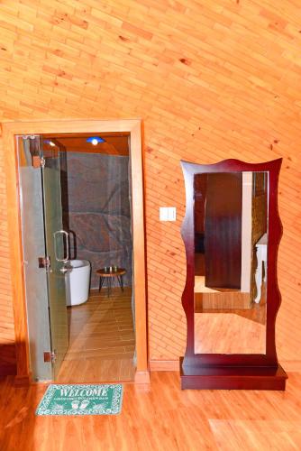 a room with a shower and a glass door at Con Khuong Resort Can Tho in Can Tho