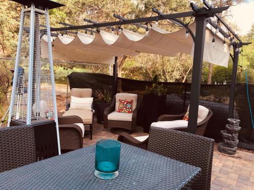 a blue glass sitting on a table under a pergola at Sedona Red Rock Garden of Paradise Pets friendly and Hot tub in Sedona