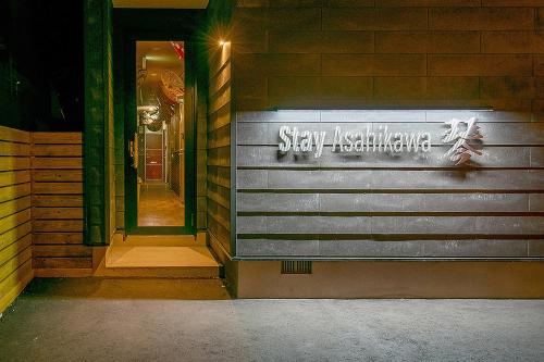 a sign on the side of a building at Stay Asahikawa Koto in Asahikawa