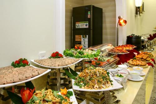 a buffet line with many different types of food at Uptown Hoi An Hotel & Spa in Hoi An