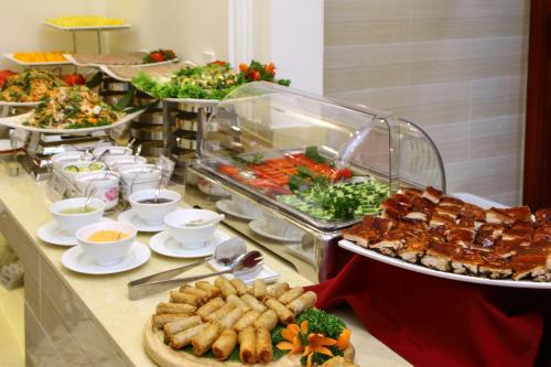 a buffet with many plates of food on a table at Uptown Hoi An Hotel & Spa in Hoi An