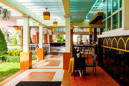 ein Restaurant mit einem Tisch und Stühlen auf einem Gebäude in der Unterkunft Krabi Front Bay Resort in Krabi