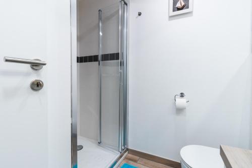 a shower with a glass door in a bathroom at Vacation Station Piran in Piran