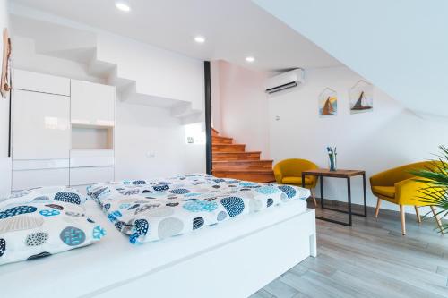 a bedroom with a bed with blue and white pillows at Vacation Station Piran in Piran