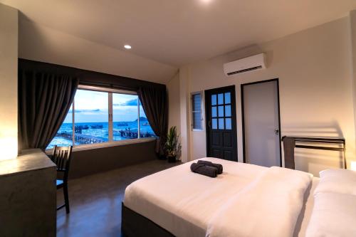 a bedroom with a large bed and a large window at Sunrise Koh Tao in Koh Tao