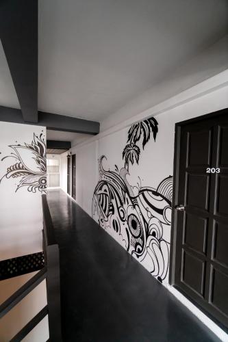 a room with a staircase with a painting on the wall at Sunrise Koh Tao in Koh Tao