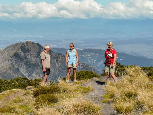 three people standing on top of a mountain at Orinoco Country Retreat in Ngatimoti
