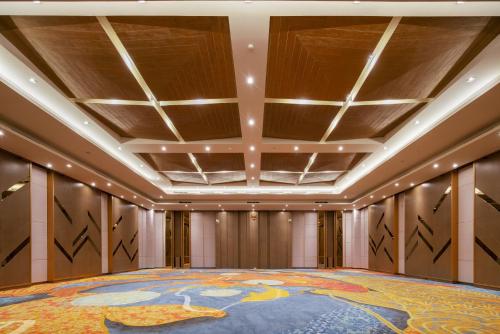 a large room with a large painting on the ceiling at Luminor Hotel Jakarta Kota By WH in Jakarta