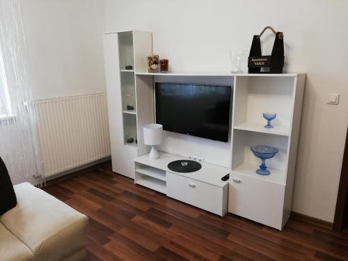 a white entertainment center with a flat screen tv at Vasco in Racibórz
