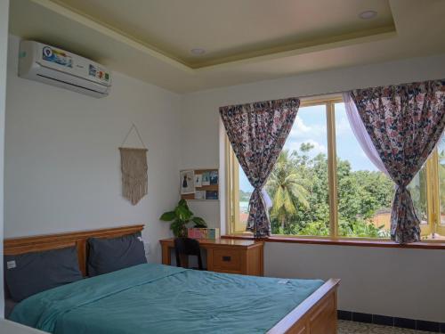 a bedroom with a bed and a window at Homestay in Tay Ninh in Tây Ninh