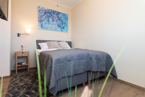 a bedroom with a bed with a blue blanket at Central Lootsi Penthouse in Tallinn