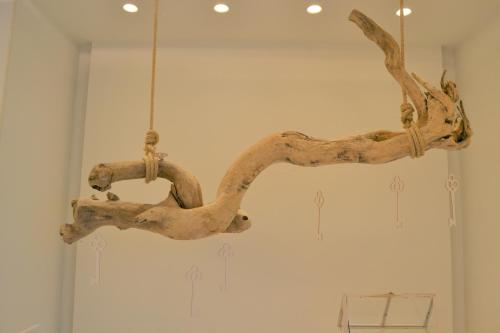 a wooden branch chandelier hanging from a ceiling at La Chiave dei Trabocchi in San Vito Chietino