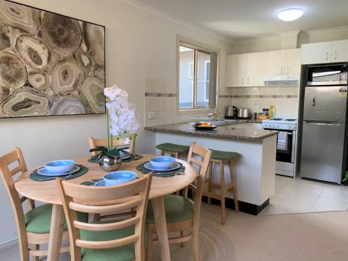 a kitchen with a table and chairs in a kitchen at Pinnacle Views in Halls Gap