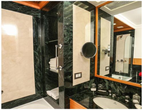 a bathroom with a sink and a mirror at Trident Chennai in Chennai