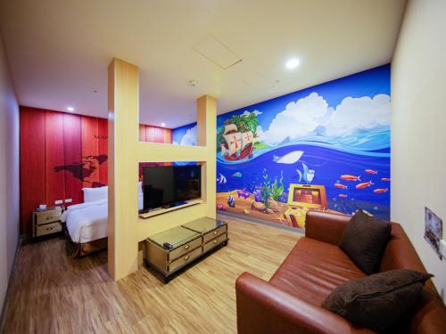 a living room filled with furniture and a tv at Skyone Hotel in Kaohsiung