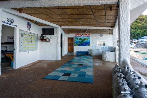 a room with a checkered floor in a building at Scandi Divers in Puerto Galera