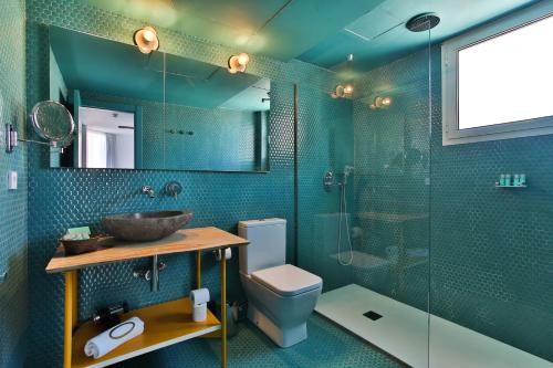 a bathroom with a toilet and a glass shower at Dorado Ibiza - Adults Only in Playa d'en Bossa