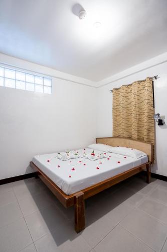 a bedroom with a bed in a room at Scandi Divers in Puerto Galera