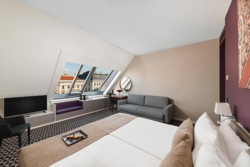 a hotel room with a bed and a tv at Hotel Moments Budapest by Continental Group in Budapest