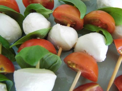 a plate of food with fruit and vegetables on sticks at Bea's Bed & Breakfast in Tavira